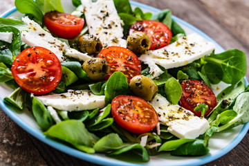 Greek salad on wooden background
