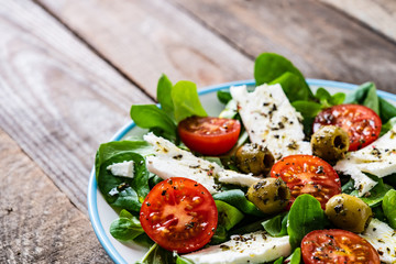 Greek salad on wooden background