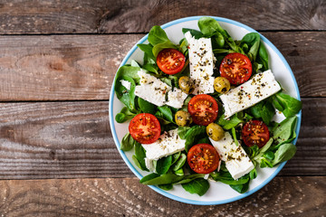 Greek salad on wooden background