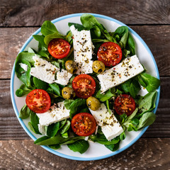 Greek salad on wooden background
