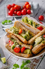 Healthy toast with vegetables, pesto and cheese