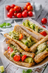 Healthy toast with vegetables, pesto and cheese