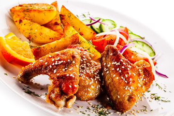 Roast chicken wings with baked potatoes