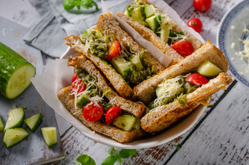 Healthy toast with vegetables, pesto and cheese