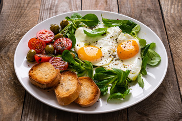 Breakfast - fried egg ,toasts and vegetabla salad