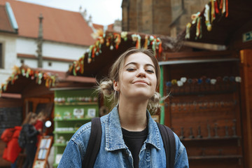 Woman on traditional Europe Sunday fair. Beautiful tourist girl chooses souvenirs