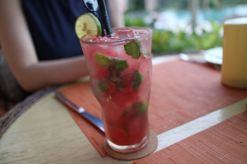 A red Mojito style cocktail to drink during lunch