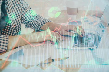 Multi exposure of stock market chart with man working on computer on background. Concept of financial analysis.