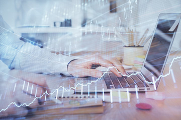 Multi exposure of stock market chart with man working on computer on background. Concept of financial analysis.