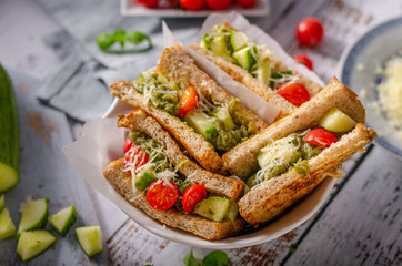 Healthy toast with vegetables, pesto and cheese