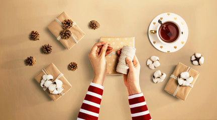 Person making present boxes with autumn theme