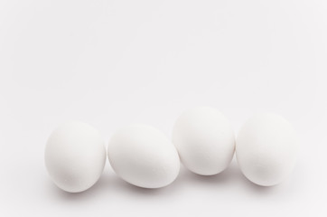 white eggs in a row - natural shapes backdrop