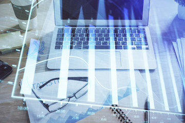 Forex market chart hologram and personal computer background. Double exposure. Concept of investment.