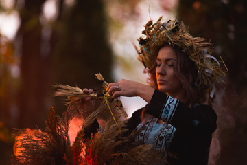 Woman sitting in burning pentagram circle, magic.