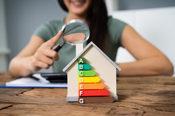Woman Calculating Energy Efficient House