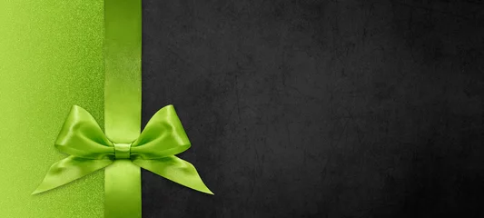 geschenkkarte wünscht frohe weihnachten hintergrund mit grüner bandschleife auf schwarz glänzender lebendiger farbtexturvorlage mit leerem kopienraum © amedeoemaja