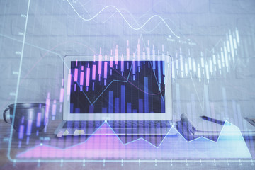 Stock market chart hologram drawn on personal computer background. Multi exposure. Concept of...
