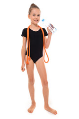 Picture of girl gymnast in black trico in full height with a jumping-rope around her neck and a...