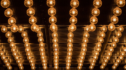 Rows of a bright ceiling lamps in a cafe