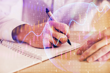 Multi exposure of man planing investment with stock market forex chart.