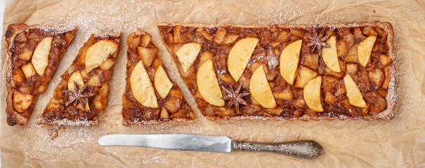 Homemade Apple tart (cake). Delicious pie with fruit, almond, cinnamon, cardamom, nutmeg, star anise and clover. A treat for tea. Thanksgiving day. Selective focus, top view