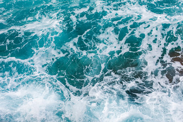 Fototapeta na wymiar Turquoise sea surface background with splashing waves