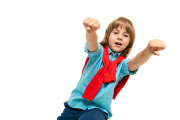 Little caucasian boy sits on a chair with red sweatshot around his neck extended hands forward isolated on white background