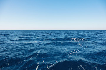 Blue sea surface with waves and horizon