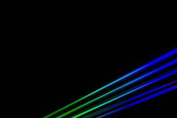 Colourfull burst of prismatic light creating lines of blured motion against a black background