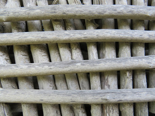 Naklejka premium Background. Window enclosure made of wood logs without bark. Martinique, French West Indies. Caribbean