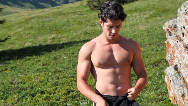 Handsome Muscular Shirtless Hunk Man Outdoor in Country Standing on Grass. Showing Healthy Muscle Body While Looking away
