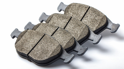 Brake pads, a set of new spare parts for servicing the car's disc brake system. Photo on a white...