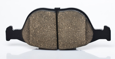One brake pad for disc brakes of a car on a white background.