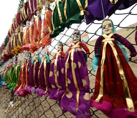 Colorful Rajasthani puppets hanging in the shop of Jaisalmer City Palace in India