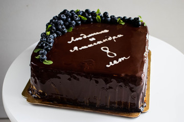 Chocolate cake with blueberries and Congratulation text.