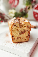 Christmas cake, milk, cinnamon on a white background by the window