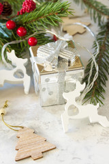 Winter Christmas background with fir branches, gifts and new year's garland.