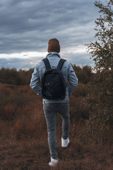 young man standing in a field