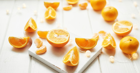 Fototapeta na wymiar Christmas oranges and tangerines on a white background by the window