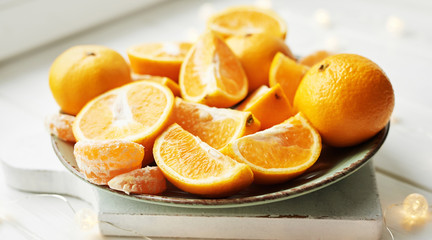 Naklejka na ściany i meble Christmas oranges and tangerines on a white background by the window