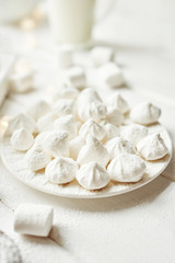 Fototapeta na wymiar christmas meringue with marshmallows on a white background by the window