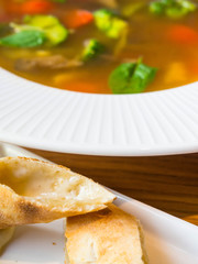 Blurred Homemade Hot soup with Vegetables, green vegearian soup, crackers with cheese, selective focus