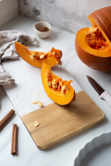 pumpkins with cinnamon sticks on marble backgrund