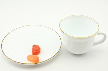 Photo of an empty white cup with a plate on a light background. The concept of lunch, breakfast.