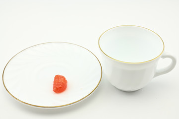 Photo of an empty white cup with a plate on a light background. The concept of lunch, breakfast.