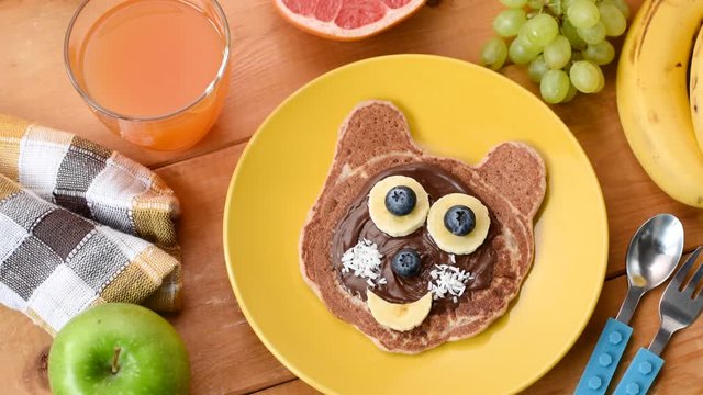 Breakfast for kids, pancake food art. Childhood, motherhood concept. Funny cute pancake animal