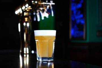 A large glass of beer at the bar. Restaurant concept. Copy space.