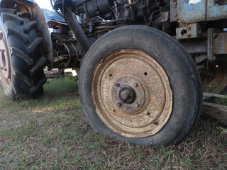 Fototapeta na wymiar wheel of a tractor, Flat tire can not continue.