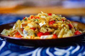 Pasta rice (orzo) with cheese and vegetable.