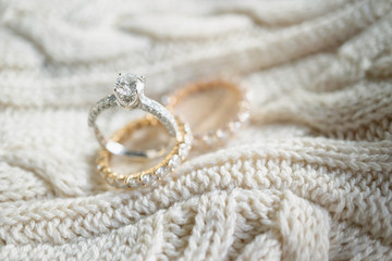 Close up of diamond ring on sweater. (soft and selective focus) love and wedding concept.